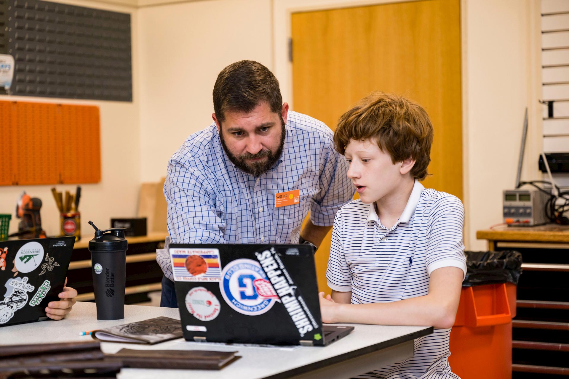 Photo of a teacher with a student working together on a laptop
