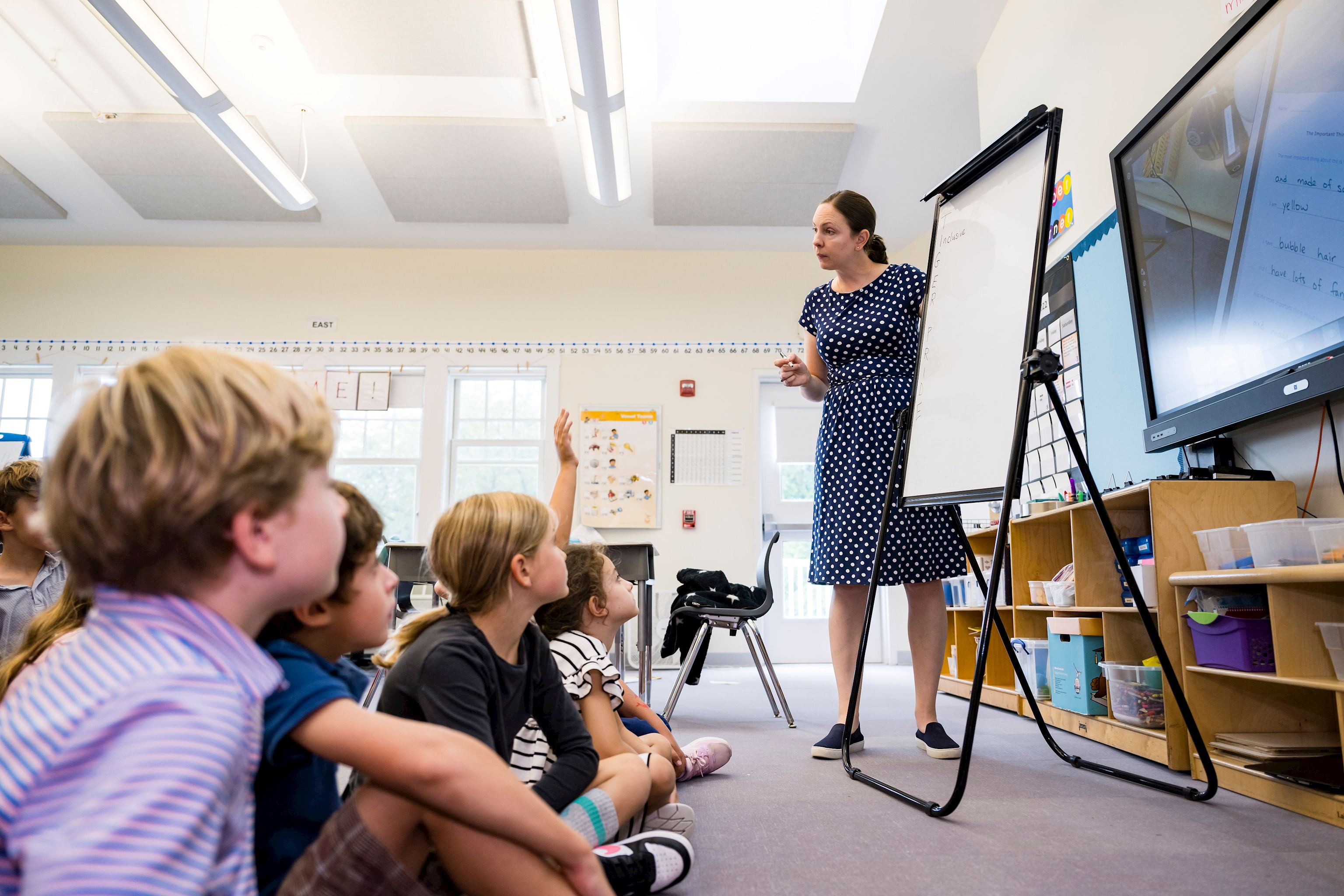 Photo of a teacher conducting a class to students