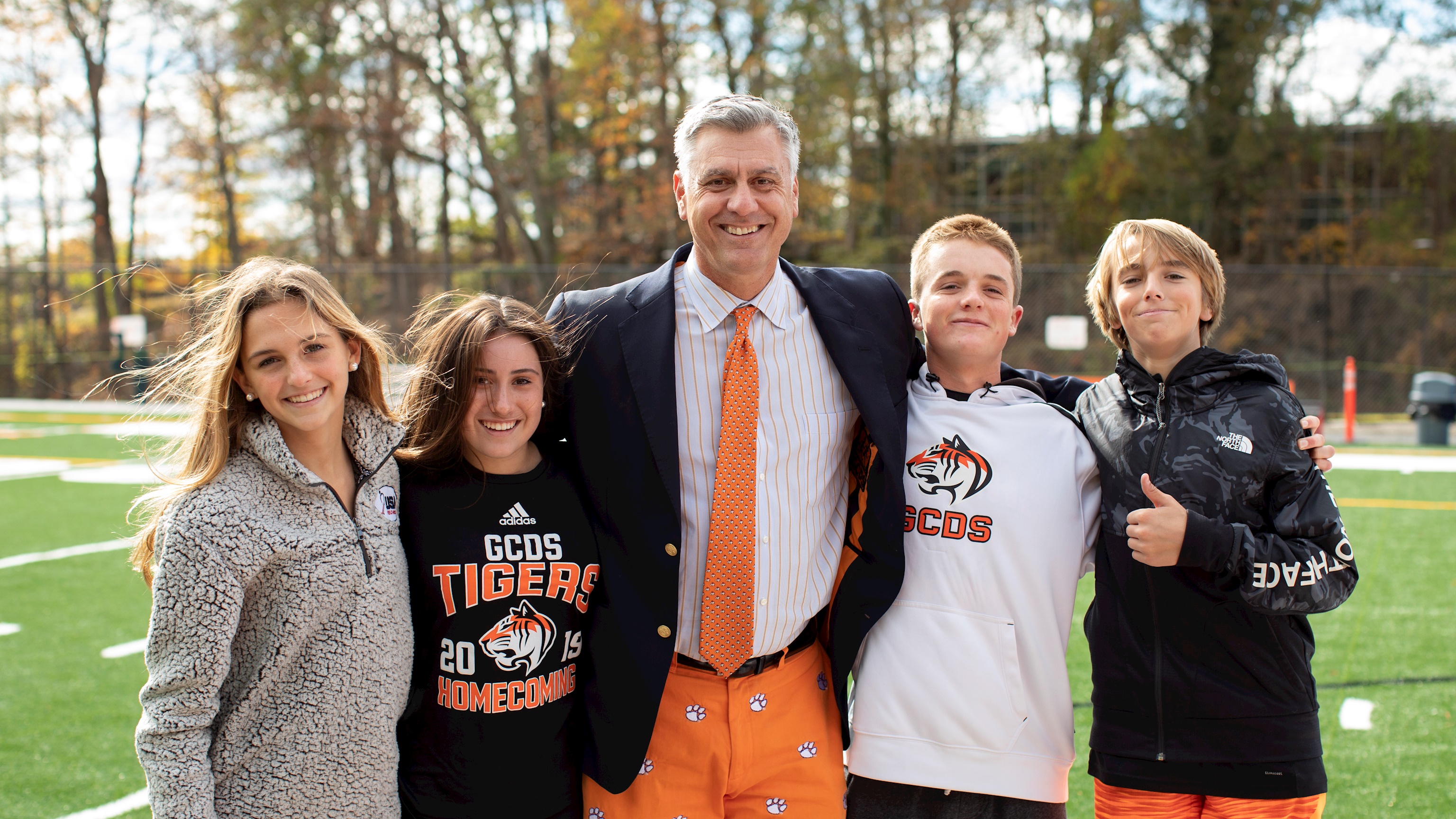 Photo of the head of school with students outside